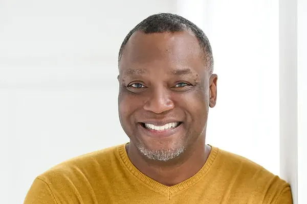 Kevin King wearing a yellow sweater, featured in CanvasRebel